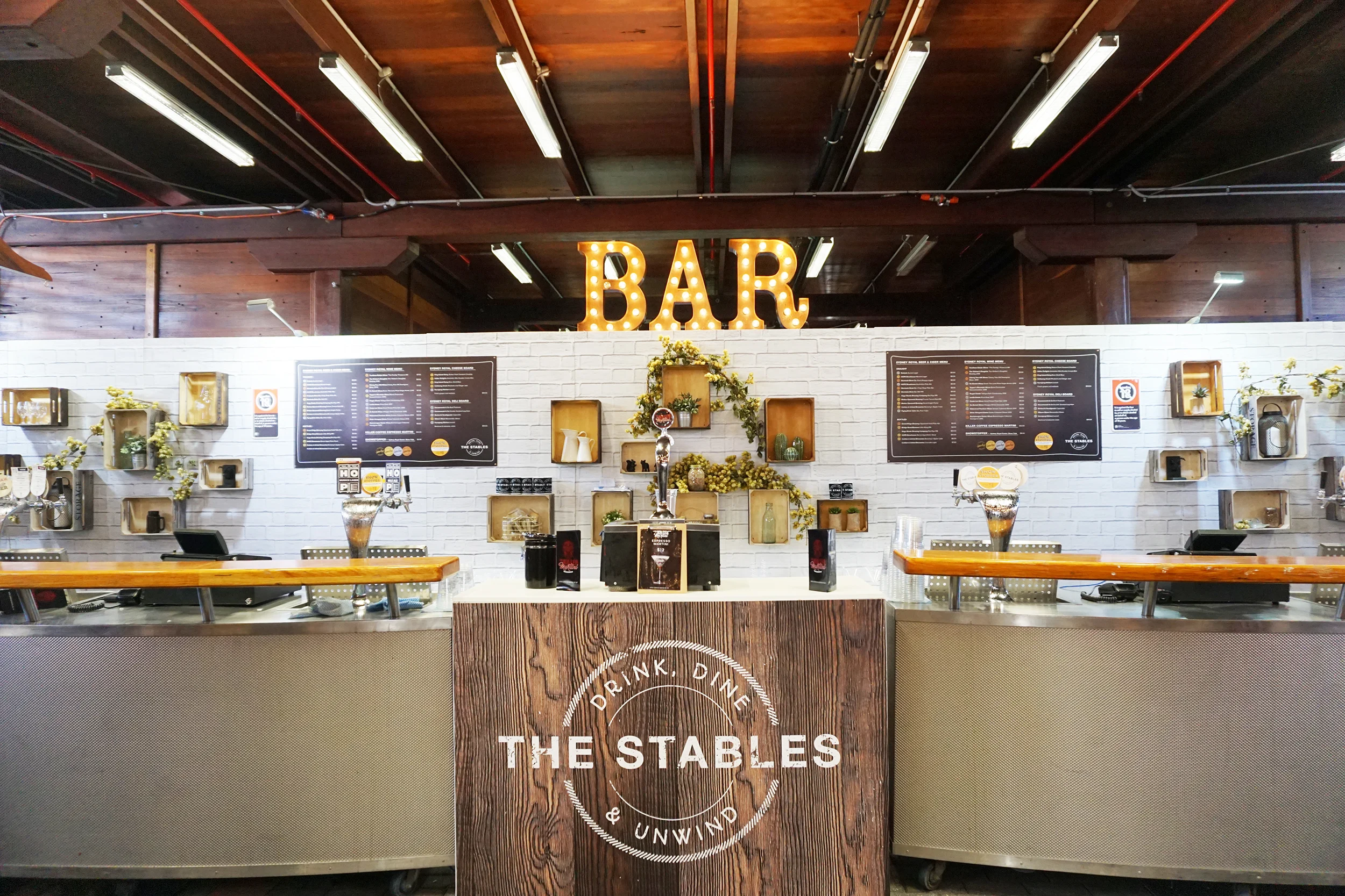 ENGIE Stadium with illuminated BAR sign and drink taps.